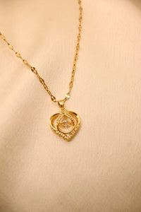 Gold heart-shaped pendant necklace with diamond accents on a delicate chain