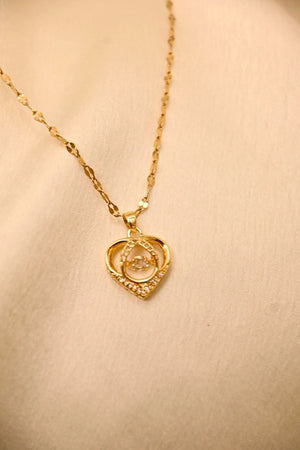 Gold heart-shaped pendant necklace with diamond accents on a delicate chain